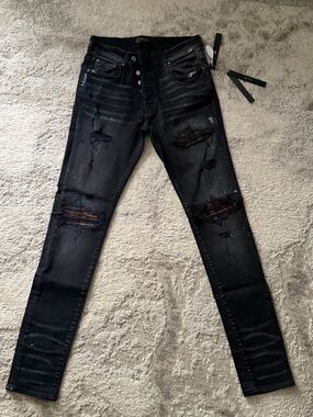 AMIRI Black Jeans with Tag Chain and Dark Accents